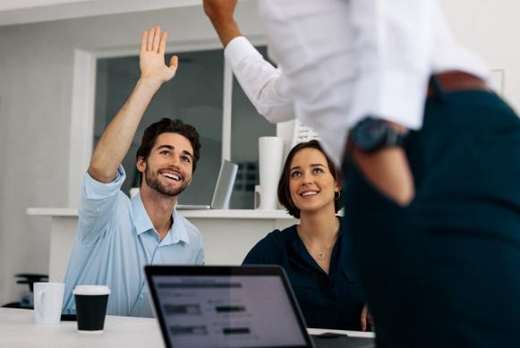 Imagen de tres personas en una oficina felices compartiendo.